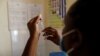 FILE - A nurse fills a syringe with malaria vaccine before administering it to an infant at the Lumumba Sub-County hospital in Kisumu, Kenya, July 1, 2022. 