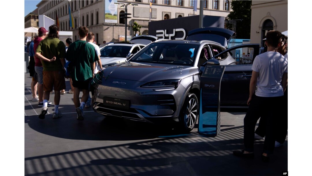 FILE - Visitors watch a BYD Seal U car at the IAA motor show in Munich, Germany, Friday, Sept. 8, 2023. (AP Photo/Matthias Schrader, File)