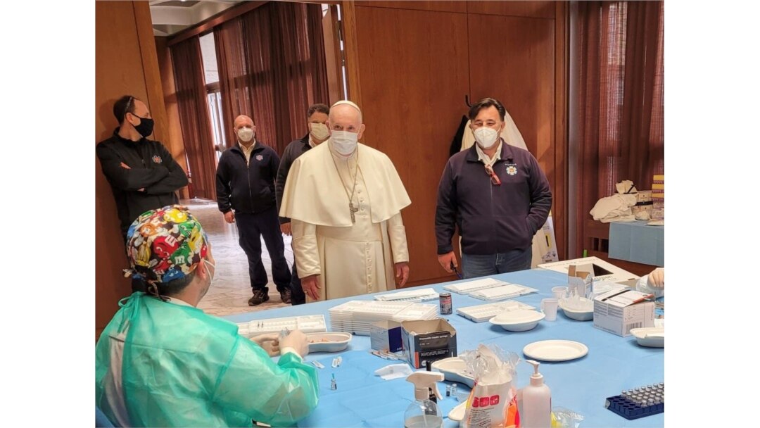 Pope Francis speaks to medical staff on Good Friday at a vaccination site at Paul VI Hall where the poor and homeless are being inoculated, at the Vatican, April 2, 2021. (Vatican Media/Handout via Reuters)