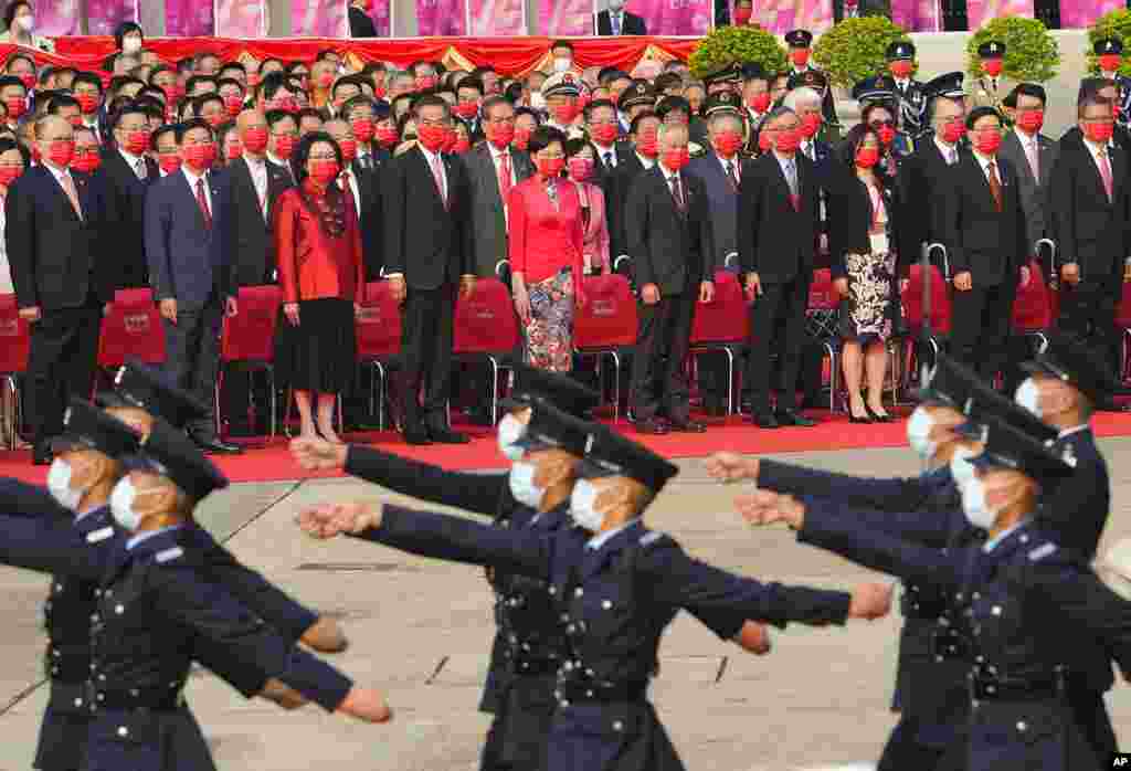 Hong Kong Chief Executive Carrie Lam, center, and other officials attend the flag raising ceremony for the celebration of China's National Day at the Golden Bauhinia Square, in Hong Kong.