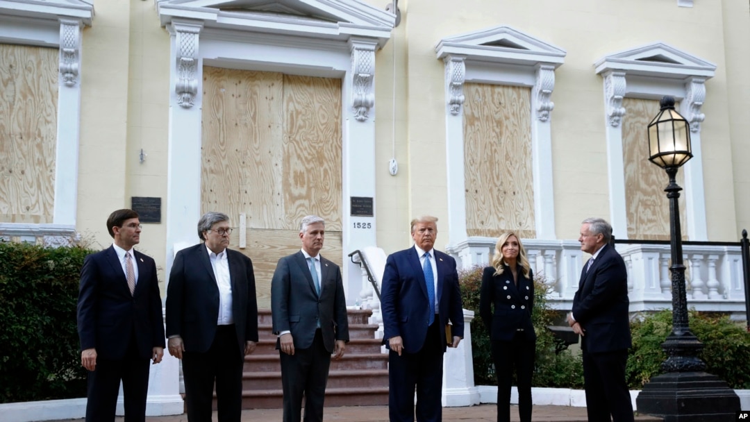 FILE - President Donald Trump stands outside St. John's Church, June 1, 2020, in Washington. Standing with Trump are Mark Esper, from left, William Barr, Robert O'Brien, Kayleigh McEnany and Mark Meadows.