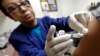 Ana Martinez, a medical assistant at the Sea Mar Community Health Center, gives a patient a flu shot, Jan. 11, 2018, in Seattle. According to an update by the Centers for Disease Control and Prevention, the flu is now widespread in every state except Hawaii.