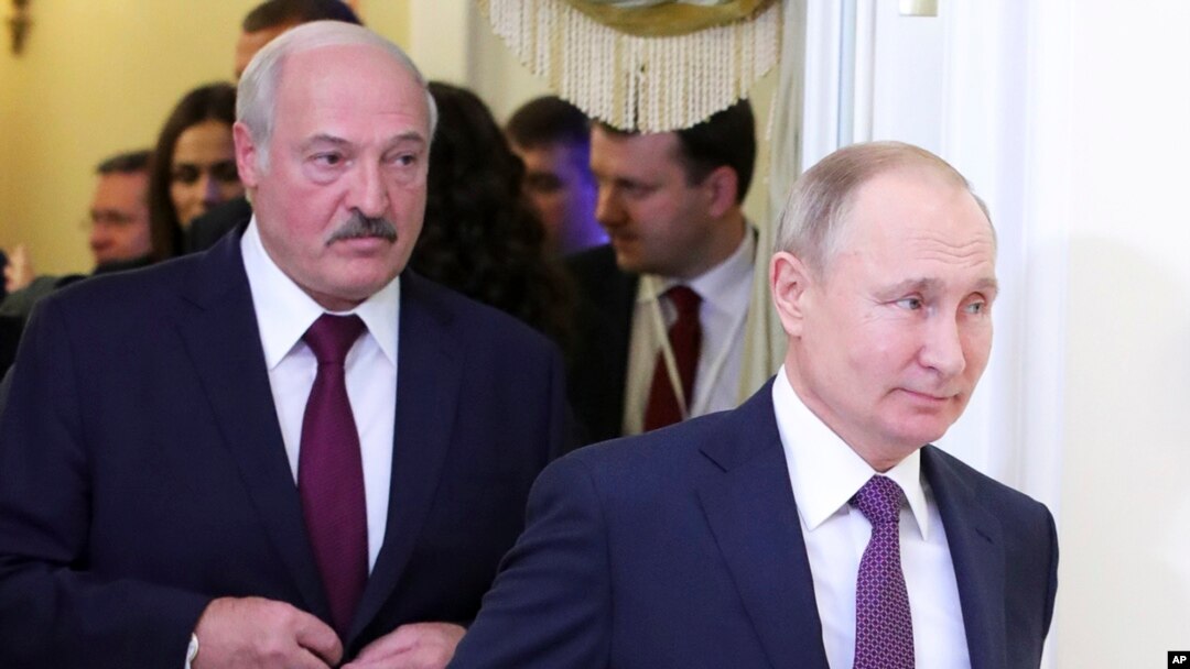 FILE - Belarusian President Alexander Lukashenko, left, and Russian President Vladimir Putin walk before a meeting in St. Petersburg, Russia, Dec. 20, 2019.