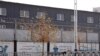 Two layers of barbed wire fencing ring the "Hotan City apparel employment training base" where Hetian Taida has a factory in Hotan in western China's Xinjiang region, Wednesday, Dec. 5, 2018. 