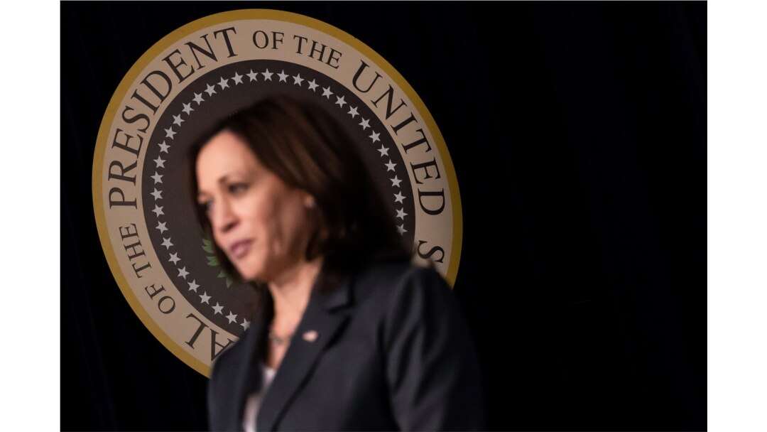 U.S. Vice President Kamala Harris stands by as President Joe Biden delivers remarks in the Eisenhower Executive Office Building's South Court Auditorium at the White House in Washington, June 2, 2021.