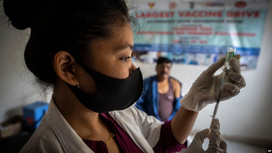 A nurse prepares to administer vaccine for COVID-19 at a private vaccination center in Gauhati, India, April 10, 2022. (AP Photo/Anupam Nath, File)