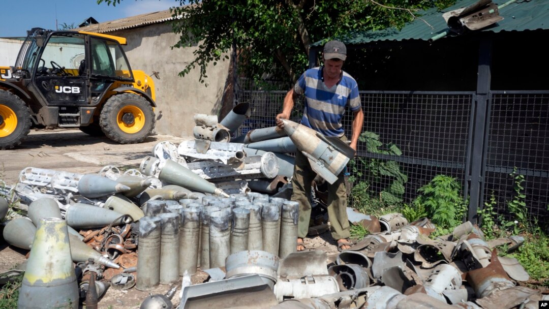 Un agricultor recoge fragmentos de cohetes rusos que encontró en su propiedad, a diez kilómetros de la línea del frente en la región de Dnipropetrovsk, Ucrania, el 4 de julio de 2022.