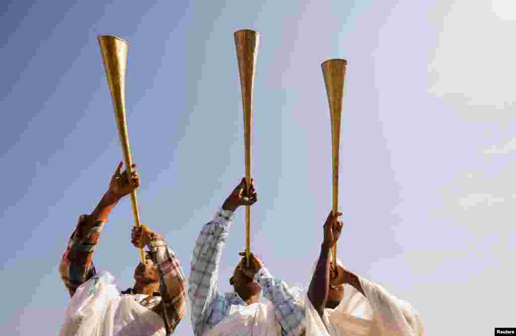 Ethiopian Orthodox faithful blow traditional trumpets during the annual Epiphany celebration called "Timket" to commemorate Jesus Christ's baptism in the Jordan River by John the Baptist, in Batu, Ethiopia.