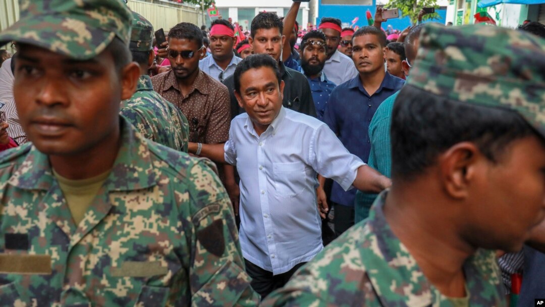 FILE - Maldivian President Abdulla Yameen, center, surrounded by body guards, arrives to address his supporters in Male, Feb. 3, 2018.