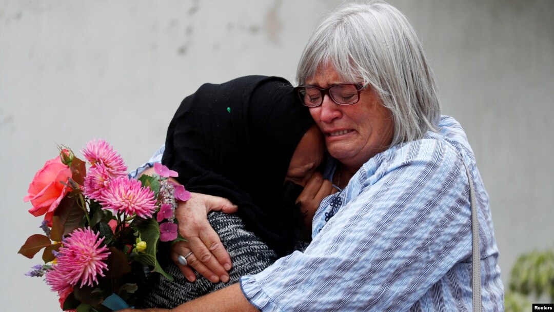 Women embrace near Masjid Al Noor mosque in Christchurch, New Zealand, March 17, 2019. 