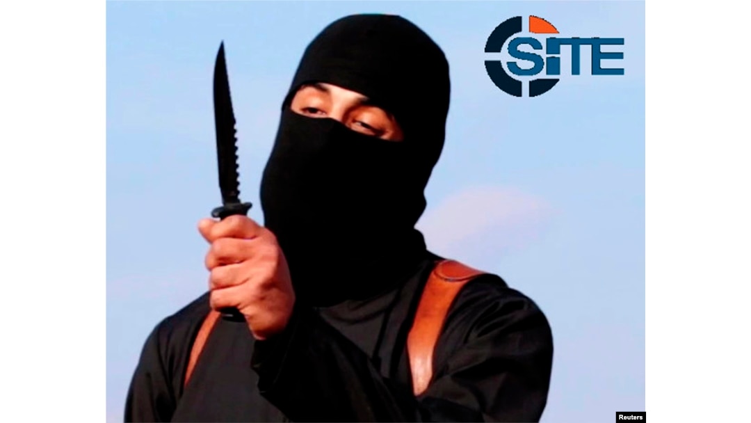 FILE - A masked militant brandishes a knife in this still image from a 2014 video. A new video purportedly shows Islamic State militants beheading three Kurdish peshmerga.