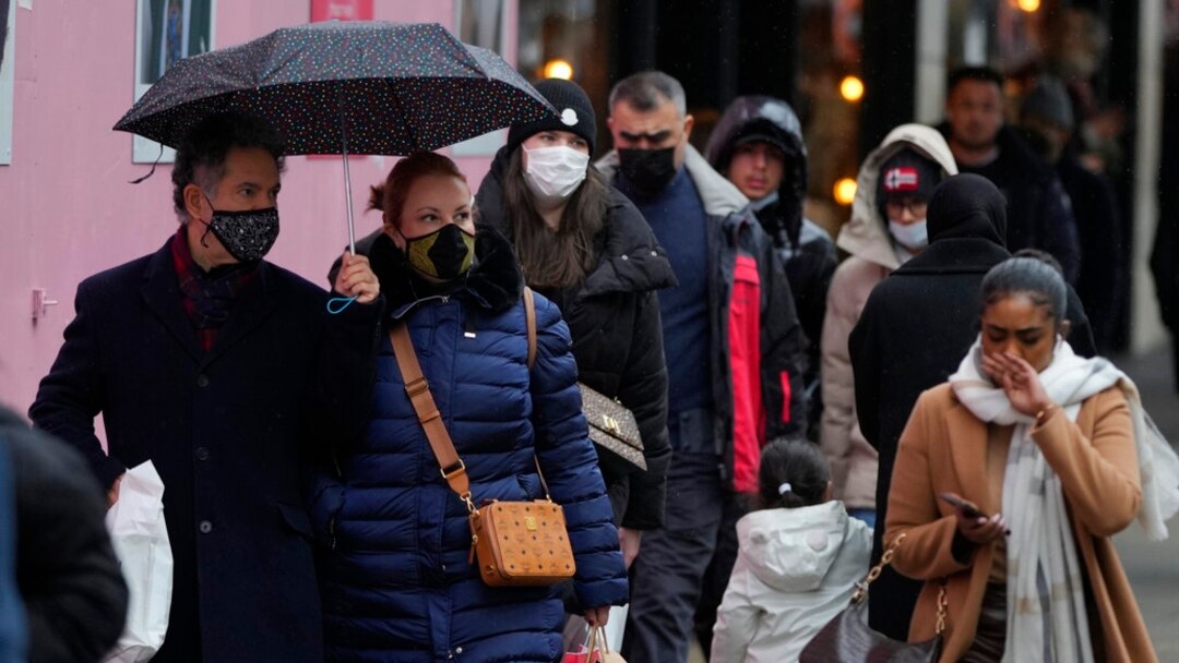 Shoppers in the crowd wear face masks against the ongoing pandemic on Oxford Street in London, Dec. 24, 2021.