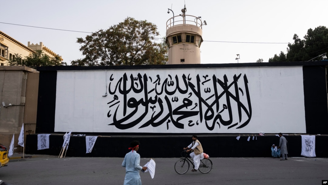FILE - The iconic Taliban flag is painted on a wall outside the American embassy compound in Kabul, Afghanistan, Sept. 11, 2021. 