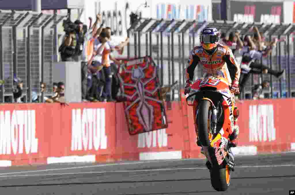 Spain's rider Marc Marquez celebrates after crossing the finish line to win the MotoGP Japanese Motorcycle Grand Prix at the Twin Ring Motegi circuit in Motegi, north of Tokyo.