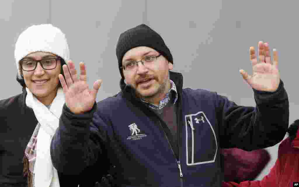 U.S. journalist Jason Rezaian gestures next to his wife Yeganeh Salehi as he poses for the media in front of Landstuhl Regional Medical Center in Landstuhl, Germany. Rezaian was released from an Iranian prison last Saturday.