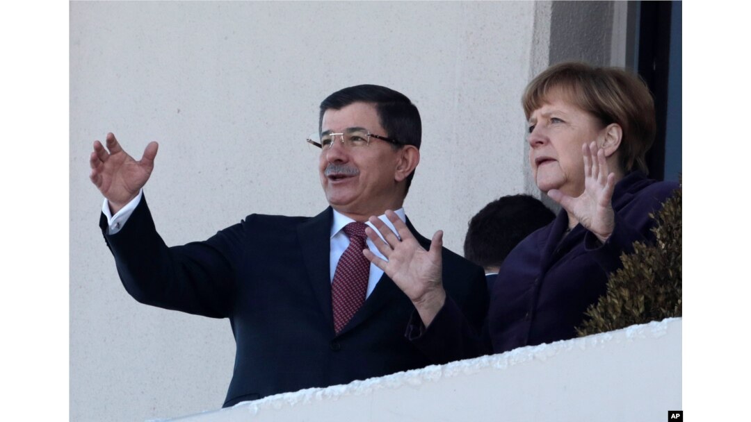 German Chancellor Angela Merkel, right, and Turkish Prime Minister Ahmet Davutoglu speak as they look toward the city center after a welcome ceremony in Ankara, Turkey, Feb. 8, 2016.