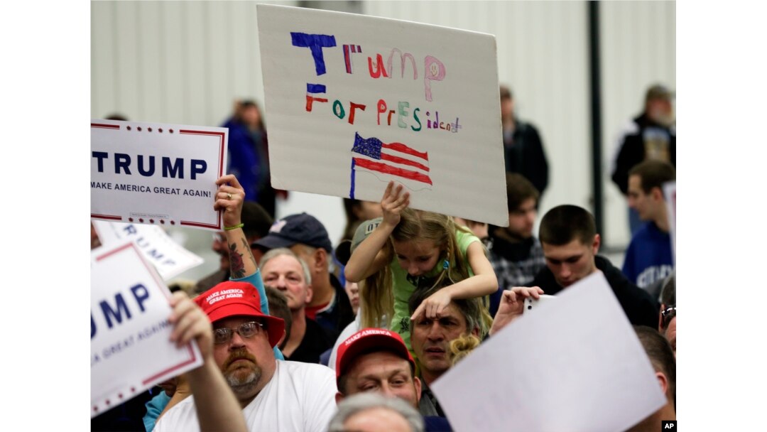 FILE - Supporters of Republican presidential candidate Donald Trump try to get autographs after a rally at Griffiss International Airport in Rome, New York, April 12, 2016.