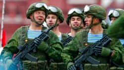 FILE - Russian paratroopers march the Victory Day military parade in Red Square marking the 76th anniversary of the end of World War II in Europe in Moscow, May 9, 2021. The amassing of Russian troops and equipment near Ukraine's border has caused worries in Kyiv and in the West that Moscow could be planning to launch an invasion.