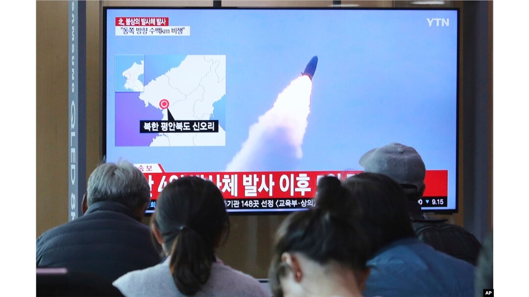 People watch a TV showing file footage of North Korea's missile launch during a news program at the Seoul Railway Station in Seoul, South Korea, Thursday, May 9, 2019.