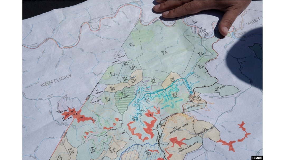 FILE - Managing Partner of CM Mining Dale Murray explains property leases on an active coal mine located next to a new solar power plant development site in Hurley, western Virginia, May 11, 2021.
