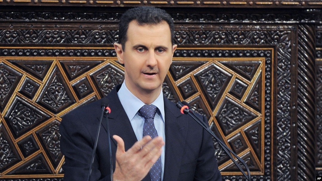 In this photo released by the Syrian official news agency SANA, shows Syrian President Bashar Assad, as he delivers a speech at the parliament in Damascus, June 3, 2012.