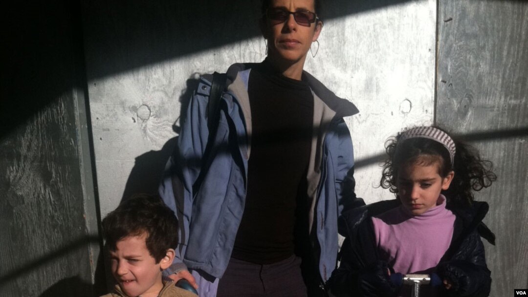 Orly and her children have grown restive after six days of no work and no school (VOA photo - A.Phillips)