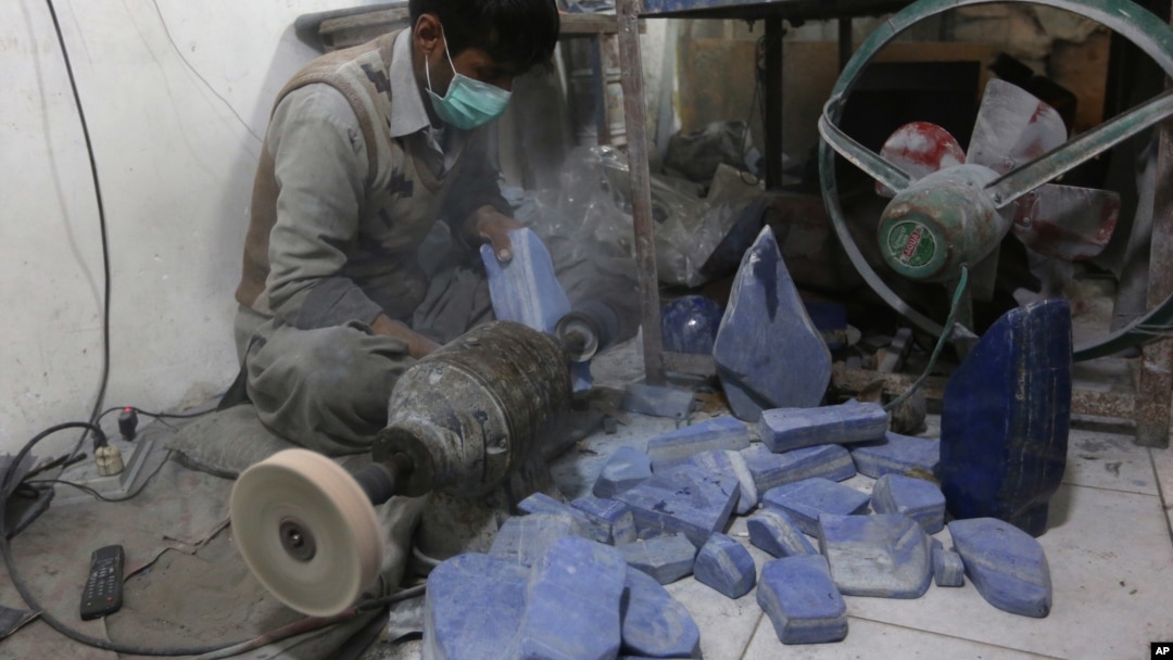 An Afghan man works at a lapis lazuli factory in the city of Kabul, Afghanistan. An international anti-corruption watchdog says Afghanistan's war is being fueled by the country's mining sector, with the Taliban earning up to $20 million a year from illegal mining of lapis lazuli on March 28, 2016.