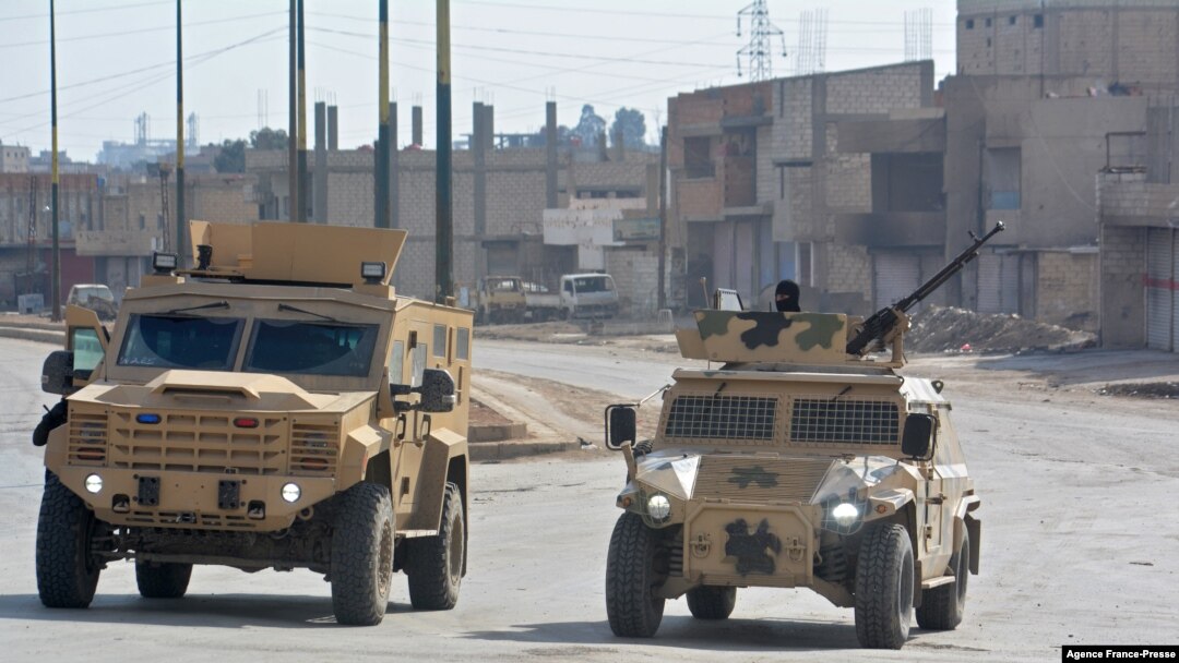 Syrian Democratic Forces (SDF) patrol a street in the northern Syrian city of Hasakeh, Jan. 23, 2022.