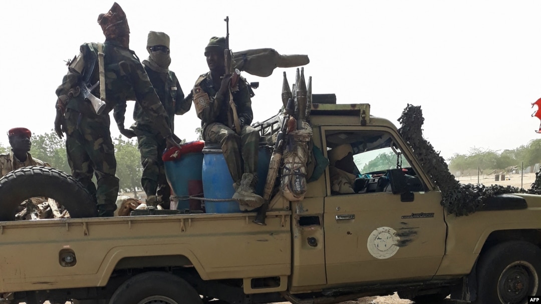 FILE - Soldiers of the Chad Army sit on the back of a Land Cruiser at the Koundoul market, 25 km from N'Djamena, Jan. 3, 2020, upon their return after a months-long mission fighting Boko Haram in neighboring Nigeria.