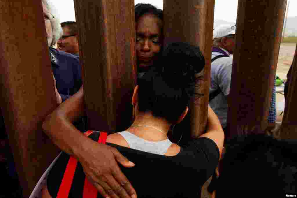 Women embrace through the border fence during the "Interfaith Service for Justice and Mercy at the Border" to demand the U.S. government to end the separation of immigrant children from their parents at the border, in Ciudad Juarez, Mexico.