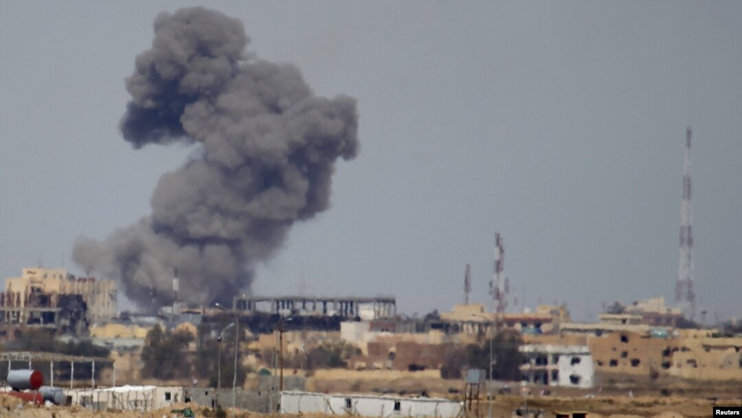 File - A plume of smoke rises above a building after an airstrike by the U.S.-led coalition battling the Islamic State group, in Tikrit, Iraq, March 2015. 