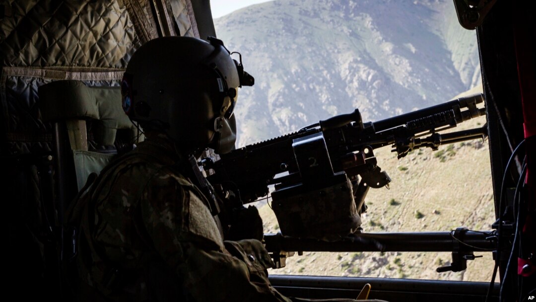 A photo released by Operation Resolite Support shows a US Army CH-47 Chinook helicopter crew scanning below near Mazar-e-Sharif, Afghanistan, June 9, 2017. 