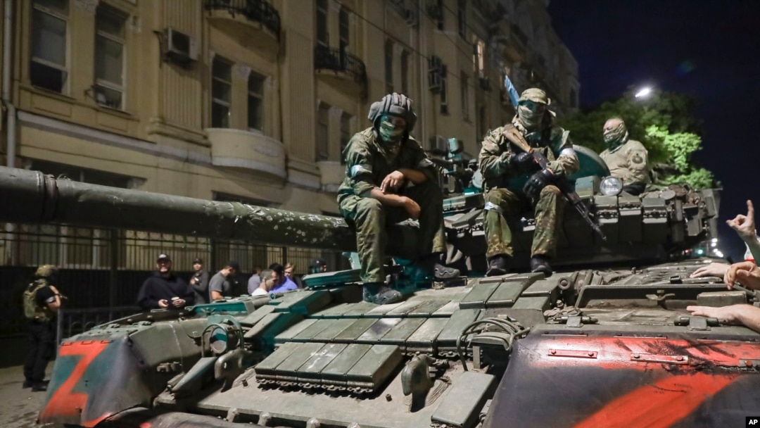 FILE - Members of the Wagner Group military company sit atop a tank on a street in Rostov-on-Don, Russia, June 24, 2023.