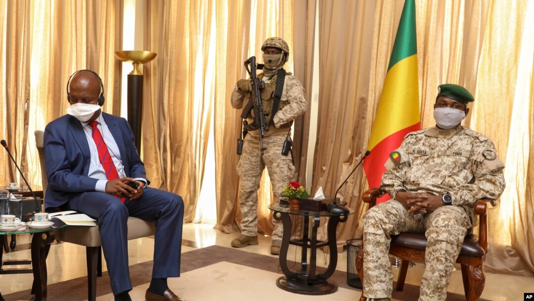 FILE - Kenya's Ambassador to the U.N. Martin Kimani, from Kenya, left, leads a United Nations Security Council mission meeting with Transition President Col. Assimi Goita, right, in Bamako, Mali, Oct. 24, 2021. 