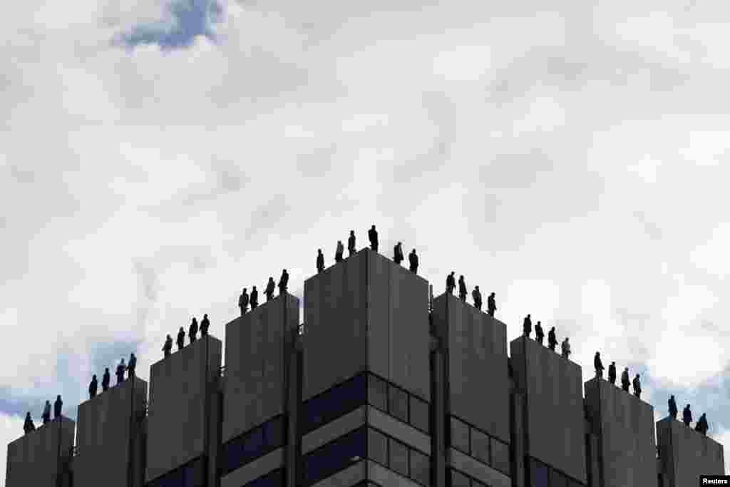 An art installation by U.S. sculptor Mark Jenkins called 'Project 84', which aims to raise awareness of male suicide rates in the United Kingdom, is seen on the roof of a building in central London, Britain.