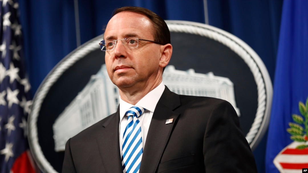 Deputy Attorney General Rod Rosenstein listens was Attorney General William Barr speaks about the release of a redacted version of special counsel Robert Mueller's report during a news conference, April 18, 2019, at the Department of Justice in Washington