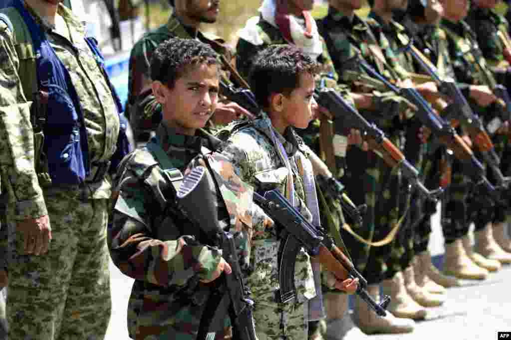 Yemeni children accompanied by their fathers hold weapons during a gathering in Sana'a to show support for the Huthi Shi'ite movement against the Saudi-led intervention.
