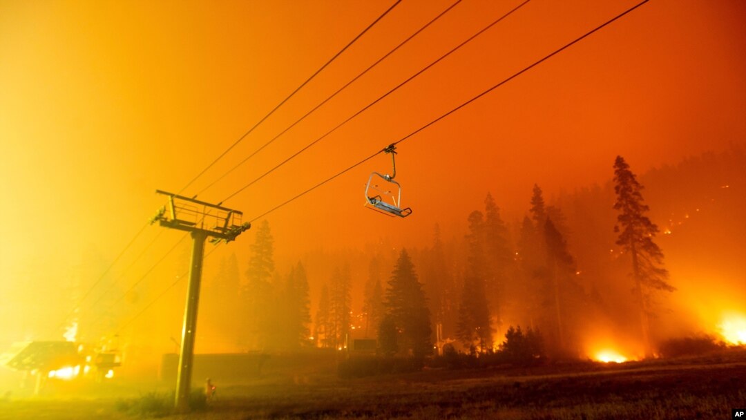 Seen in a long camera exposure, the Caldor Fire burns at the Sierra-at-Tahoe ski resort on Aug. 29, 2021, in Eldorado National Forest, Calif. 