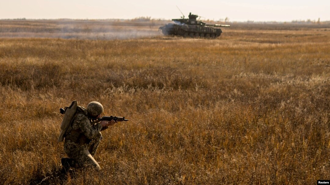 FILE - A serviceman of the Ukrainian Armed Forces takes part in military drills at a training ground near the border with Russian-annexed Crimea in Kherson region, Ukraine, in this handout picture released by Ukraine's military.