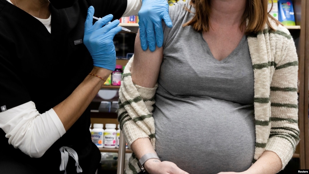 FILE - A pregnant woman receives a vaccine for the coronavirus disease (COVID-19) at Skippack Pharmacy in Schwenksville, Pennsylvania, Feb. 11, 2021.