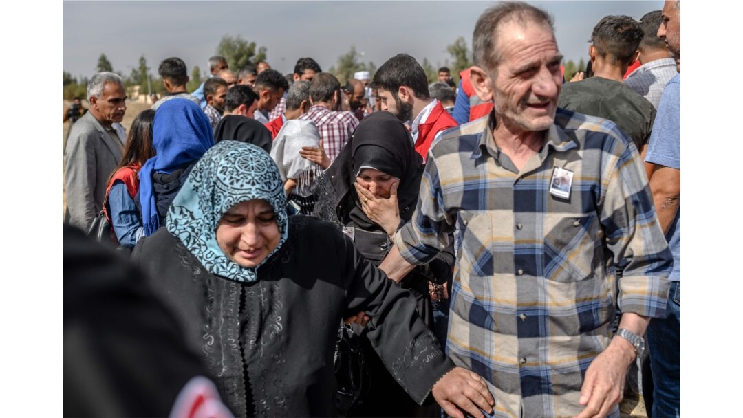 Syrian refugees and relatives of nine-month-old baby, Mohammed Omar, killed in a mortar attack a day earlier in Akcakale near northern Syria, leaves after funeral ceremony in Akcakale on October 11, 2019.