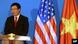 FILE - Vietnamese Foreign Minister Pham Binh Minh speaks during a joint press conference with U.S. Secretary of State John Kerry in Hanoi, Dec. 16, 2013. 