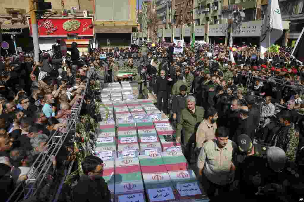 Flag-draped caskets of those who died in Saturday's terror attack on a military parade are laid out during a mass funeral, in the southwestern city of Ahvaz, Iran. Thousands of mourners gathered at the Sarallah Mosque on Ahvaz's Taleghani junction, carrying caskets in the sweltering heat.