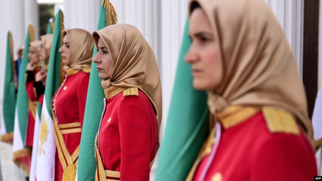 FILE - Mujahedin-e Khalq honor guard members stand watch in Manza, Albania, July 12, 2019. An Iranian paramilitary network was allegedly targeting Mujahedin-e Khalq group members in Albania, police said Wednesday.