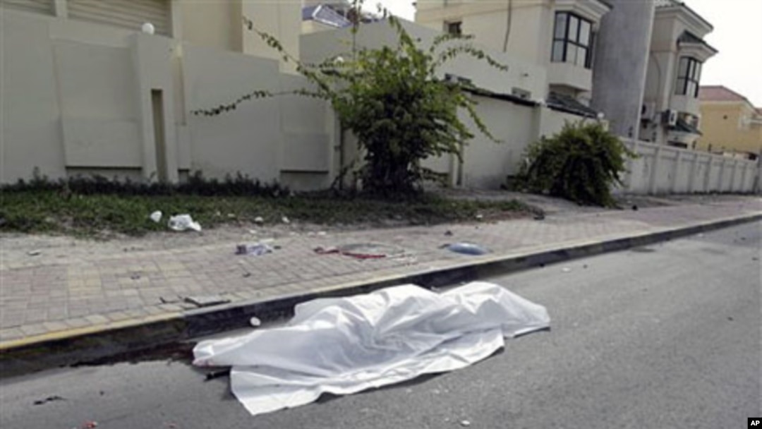 The body of a person killed during clashes between demonstrators and police lies in the street in Manama, on Feb 17 2011