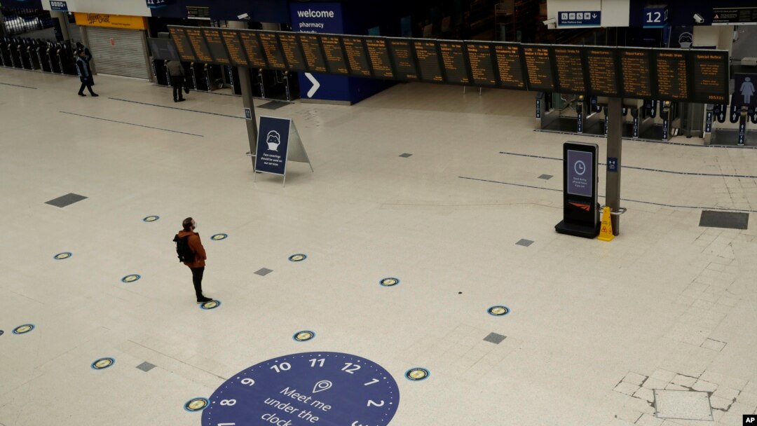 Social distancing guidelines on the floor by train departure information screens to help stop the spread of coronavirus in Waterloo station, London, June 4, 2020.