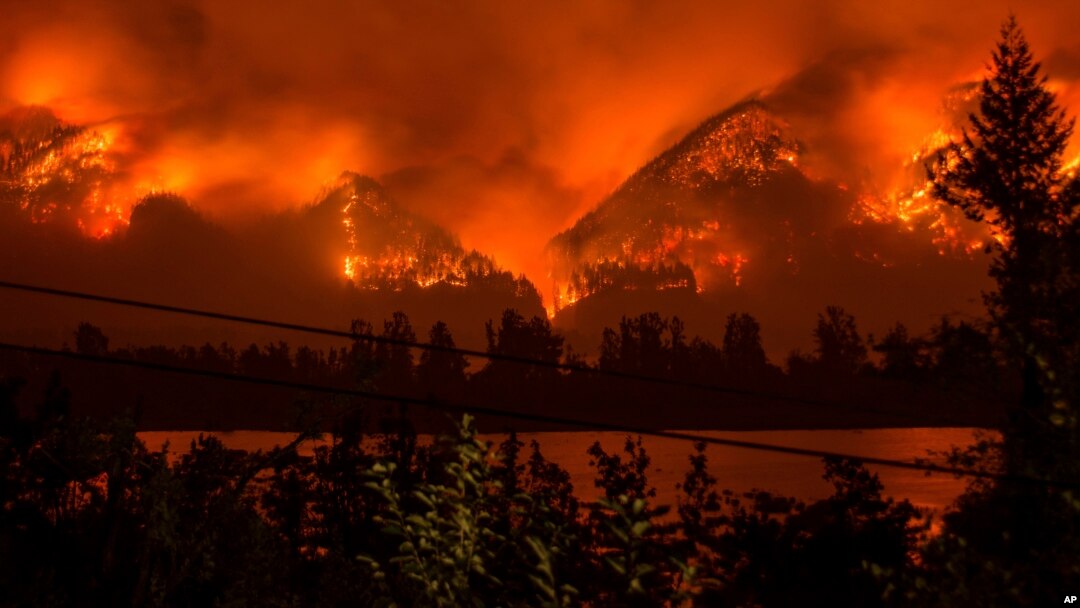 FILE - The Eagle Creek Fire, as seen from near Stevenson, Washington, across the Columbia River, burns in the Columbia River Gorge above Cascade Locks, Oregon, Sept. 4, 2017.