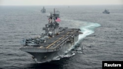 FILE - The amphibious assault ship USS Boxer transits the East Sea during an exercise, March 8, 2016. The Boxer Amphibious Readiness Group has been sent to waters off the coast of Yemen.