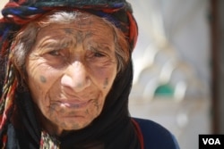 One-hundred-year-old Tamam Shaheen balked at IS orders to veil her face or quit smoking, but in the wake of IS rule, her grandson is now imprisoned and accused of having fought alongside the group, in Sarran, Syria, Aug. 18, 2017. (H. Murdock/VOA)