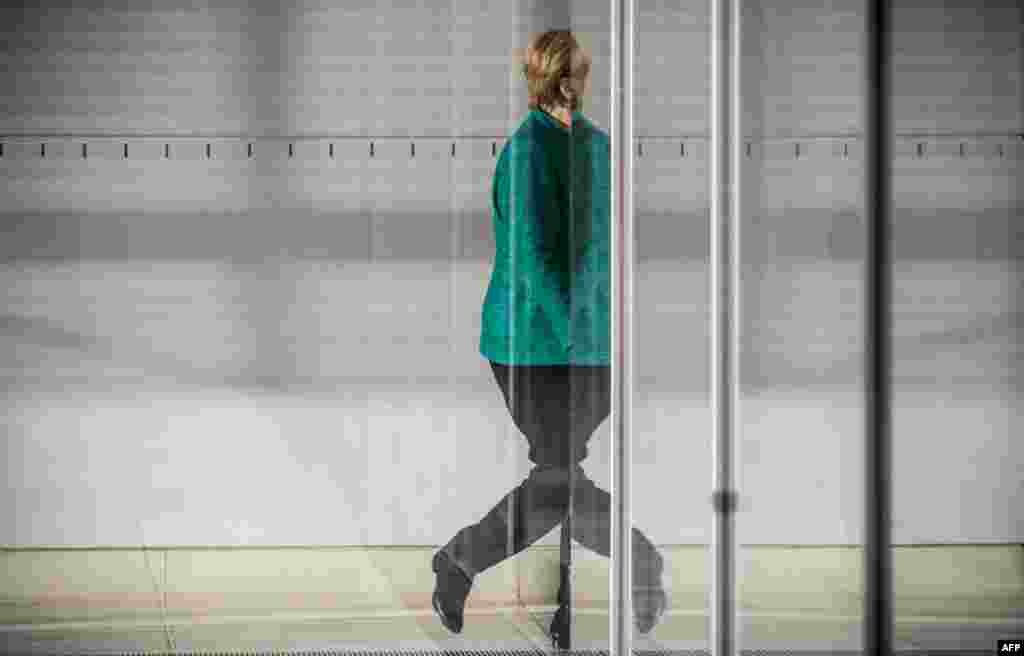 German Chancellor and leader of the Christian Democratic Union party, Angela Merkel leaves the parliamentary compound of the Bundestag in Berlin after the parliamentary group of the CDU/CSU elected a new leader.